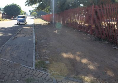 Moving of existing sidewalk to boundary of school fence for construction of a safe drop-off zone